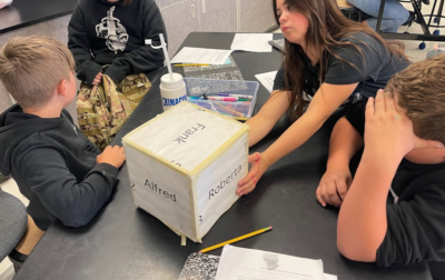 Students with the name and number cube.