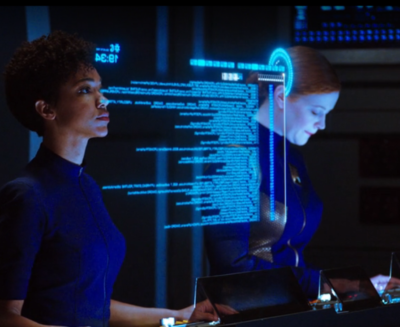 Scene from Star Trek Discovery where Michael Burnham uses a computer to troubleshoot problems with some code.