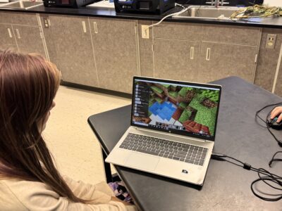 Student showing her Minecraft happy place build.